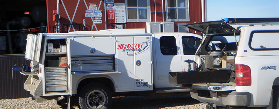 Flomax Compression Service truck in the Field Flomax Compression Field Service truck in action at compressor station that looks like a Barn