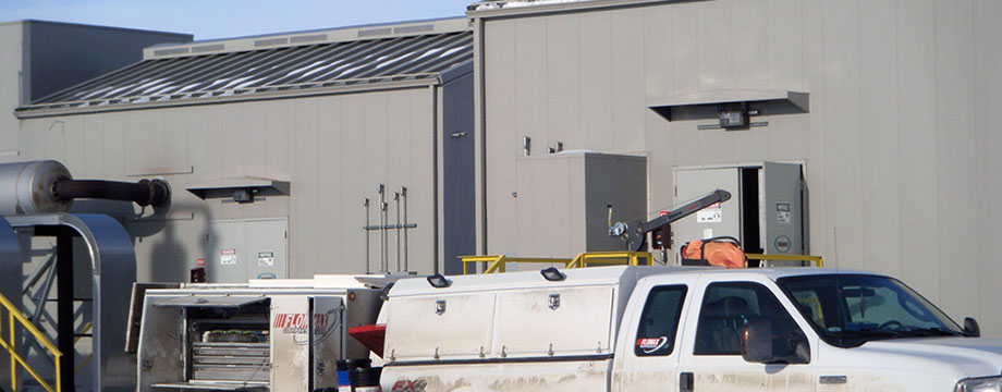 Field service truck in front of Compressor building Field service truck in front of compressor station in winter