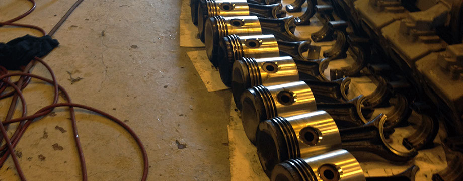 Waukesha 7042GL pistons and Conrods A image of 12 Waukesha 7042GL pistons and conrods laying on there sides for inspection